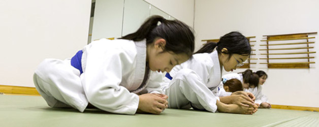 Young students stretching and warming up during children's martial arts class at Eugene Dojo Oregon